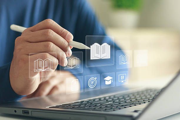 istock Digital learning concept showing a person using a stylus with virtual education icons on a laptop, representing e-learning, online study, knowledge sharing and modern digital education technology. 2243491347