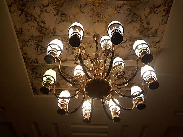 istock Illuminated chandelier hanging with textured ceiling. 2243492623