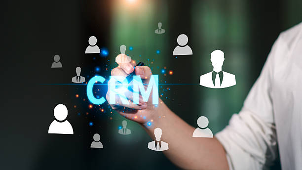 istock CRM system concept with business person interacting with glowing digital customer icons, representing relationship management, data analytics, communication, technology improving client engagement 2243492667