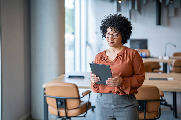 istock Confident mature businesswoman using digital tablet in modern office 2243493313