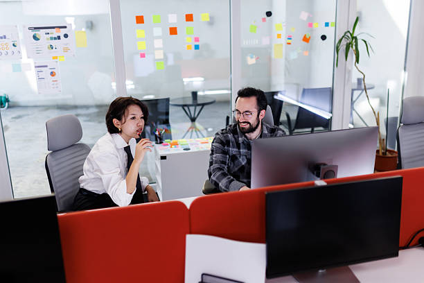 istock Business professionals collaborate in a modern office setting while sharing ideas and enjoying a drink during a productive work session in the afternoon 2243493955