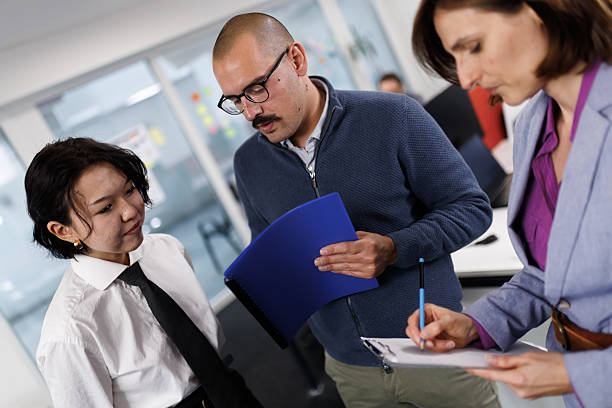 istock Business professionals engaging in conversation and collaboration in a modern office environment during a team meeting 2243493989