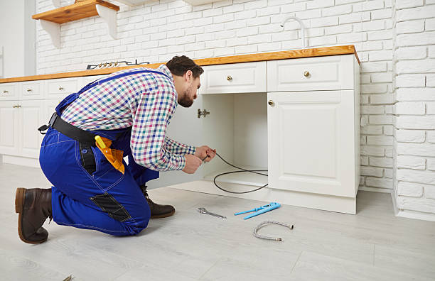 istock Male plumber repair pipe under sink in kitchen 2243494582