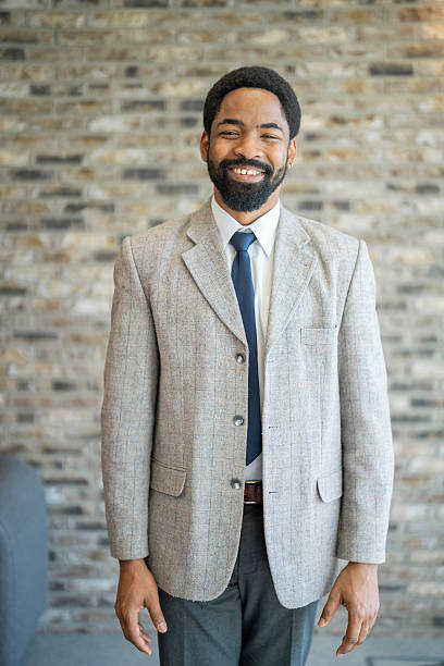 istock Smiling businessman wearing suit and tie in office setting 2243495386