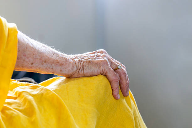 Sydney, Darling Harbour, NSW, Australia - October 19, 2025: Closeup sitting senior woman hand with diamond ring on finger and resting on knee, traveling on ferry from Darling Harbour