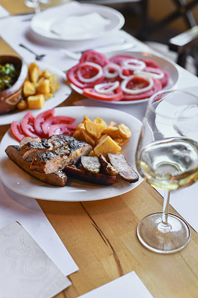 istock Plated Grilled Meat, Crispy Potatoes, and Fresh Tomato Onion Salad for a Shared Meal 2243501184
