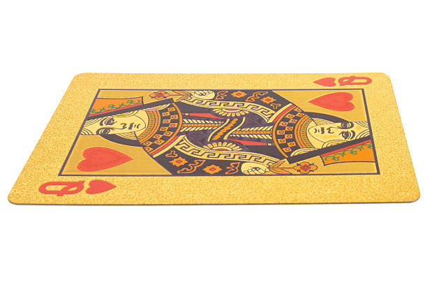 Deck of playing cards standing on black background and queen is on top of the deck.
