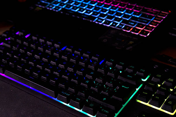 istock Mechanical and laptop illuminated keyboards, gaming set up, upper view 2243508738