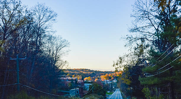 istock Scenic Autumn Road Leading to Small Town 2243508909