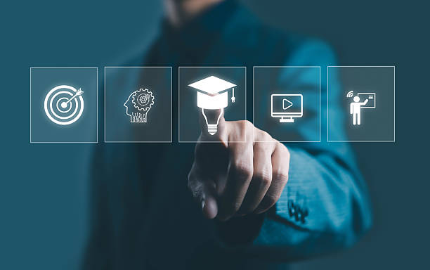 istock Businessman touching virtual icons of education, target, idea, and online learning on digital interface, symbolizing e-learning, innovation, and knowledge development in modern technology. 2243510108