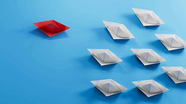 istock concept 3D paper ship on opposite direction with isolated blue background.3D rendering on blue background. 2243510188