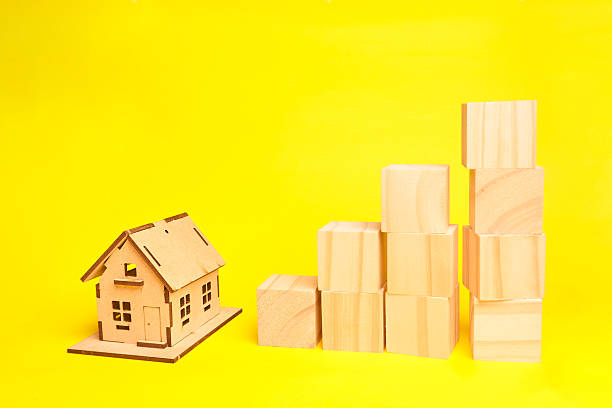 istock House model beside ascending wooden blocks visualizing real estate value growth investment strategy and building long term wealth. 2243510955