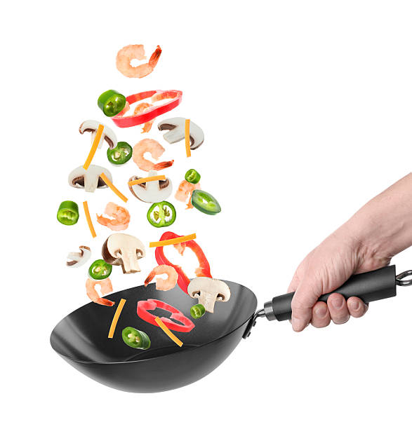 istock Man tossing ingredients in wok on white background, closeup 2243512136