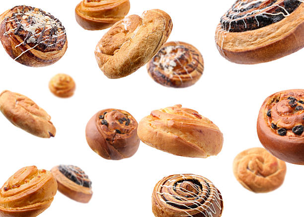 istock Sweet buns. Different delicious rolls falling on white background 2243512156