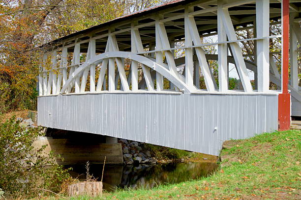 Manns Choice, Pennsylvania, USA - October 19, 2025: The historic Turner Covered Bridge crosses the Juniata River in the Susquehanna Valley of western Pennsylvania.