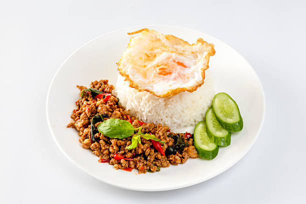 istock Rice topped with stir-fried basil and fried egg on a white background 2243516891