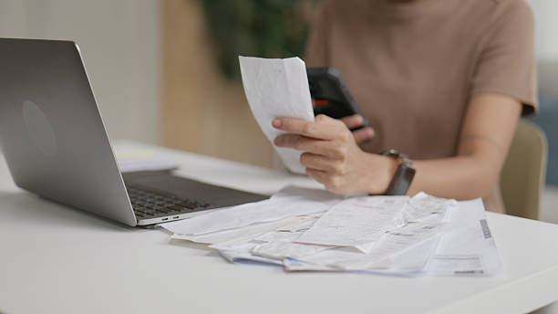 istock Asian Woman Calculating Expenses and Bills Using Tablet.4k 2243517287