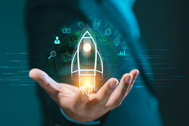 istock Hand presenting a glowing rocket icon over a global network, surrounded by business symbols. Signifies startup launch, innovation, future vision, and business acceleration. 2243521054