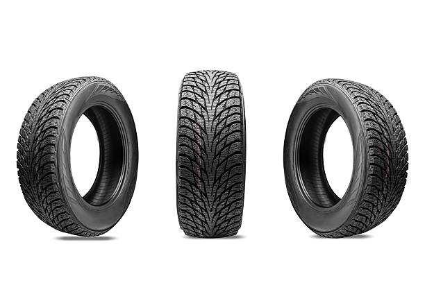 istock Three winter tires without spikes, with a friction winter compound and multiple slats for effective braking on ice, on a white transparent background. Presentation of winter wheels during the tire change season 2243528657