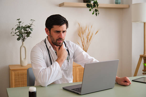 istock Thoughtful Doctor Working on Laptop in Modern Office 2243530114