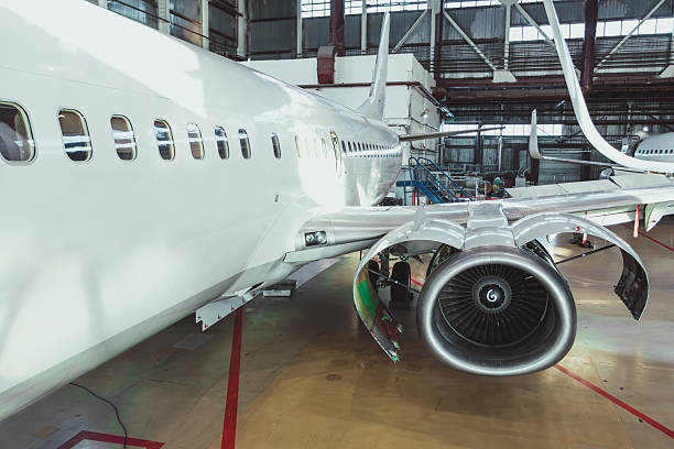 istock White passenger plane in the aircraft hangar. Airliner under maintenance 2243531996
