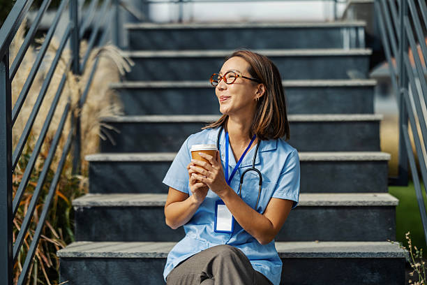 istock Healthcare professional enjoying coffee break outdoors on steps 2243533147