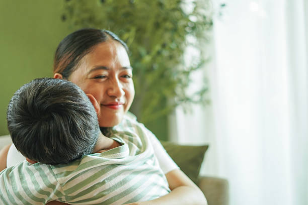 istock Son happily hugs his mother at home. 2243533842