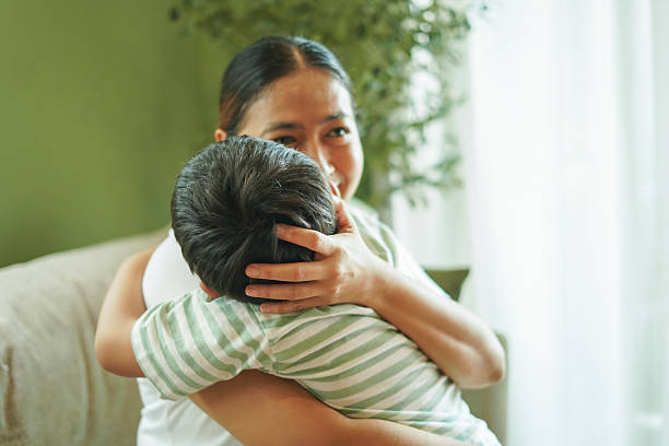 istock Son happily hugs his mother at home. 2243533852