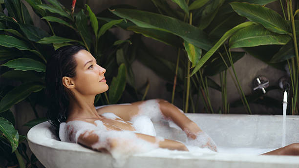 istock Tranquil Woman Relaxing In Tropical Foam Bath Surrounded By Lush Greenery 2243536444