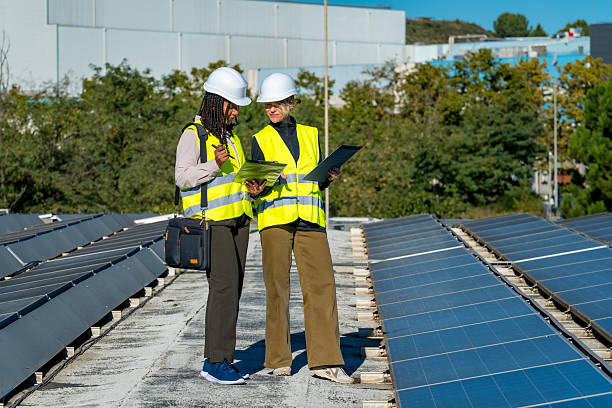 istock Women engineers inspecting solar panels on a rooftop 2243537641