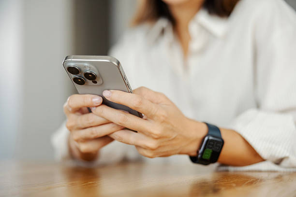 istock Woman texting on smartphone with a wearable device 2243537663