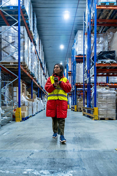 Woman scanning inventory in cold storage warehouse logistics