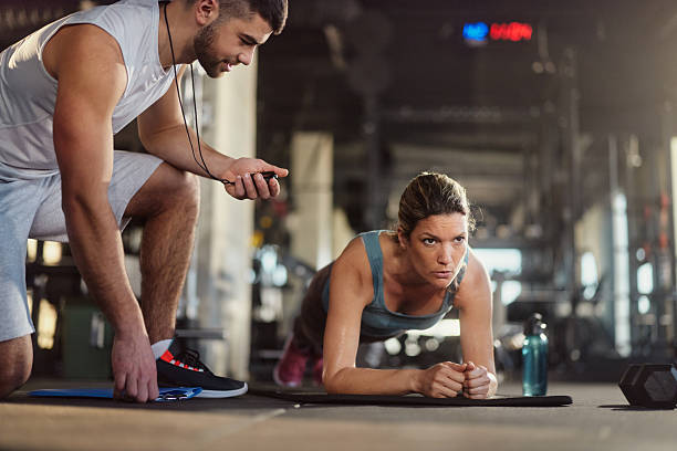 istock Athletic woman having strength training with her coach in a gym. 2243539992