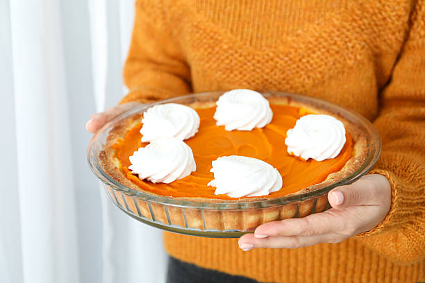 Woman hold in hands pumpkin pie, close up