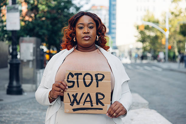 istock Woman activist holding stop war sign 2243541431