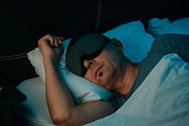 istock a man resting with a sleep mask in a bedroom 2243543414