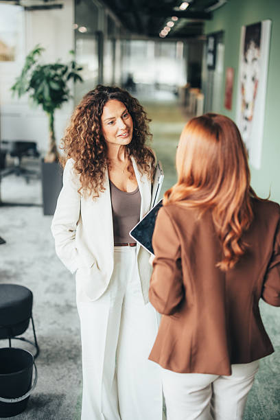 istock Confident female professionals talking on the go 2243544944