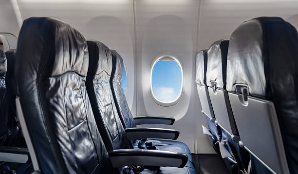 istock Empty airplane seats and windows with blue sky view during flight.inside plane for travel concepts,airline promotion,passenger experience,transportation ads,holiday vocation in flight services visuals 2243545546