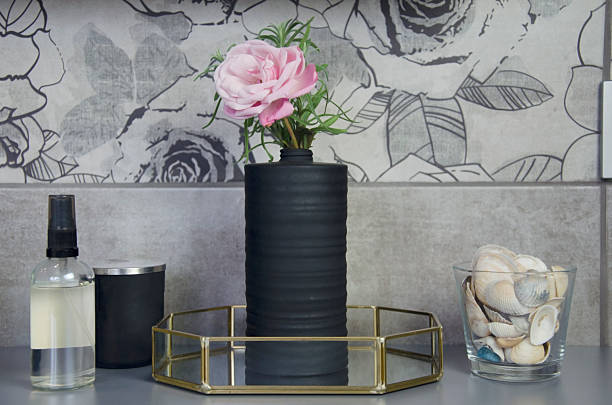 istock Modern bathroom decor with black vase, pink flower and seashells 2243545753