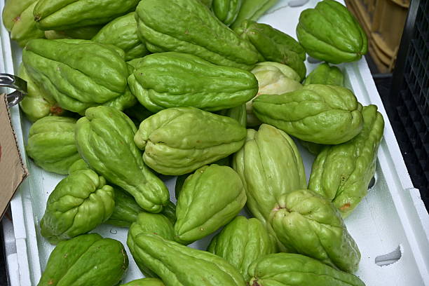 istock Fresh chayote squash with ridged texture in white container at market 2243546227