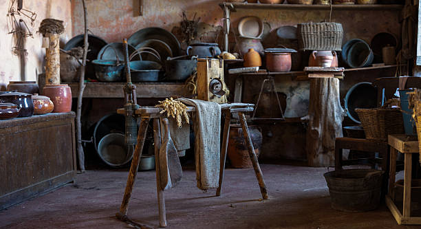 istock Vintage Rustic Kitchen Interior with Traditional Pottery and Antique Agricultural Tool on Wooden Table 2243546409