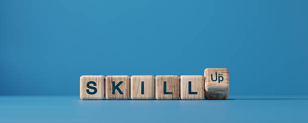 istock Skill up concept with wooden cubes forming the word SKILL UP on blue background. Learning, training, self development, education, and career growth motivation idea. 2243551706