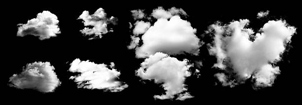 istock Fluffy white clouds isolated on black background, showcasing various shapes and sizes 2243560083