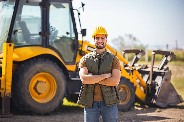 istock Young excavator operator standing in front of excavator 2243560656