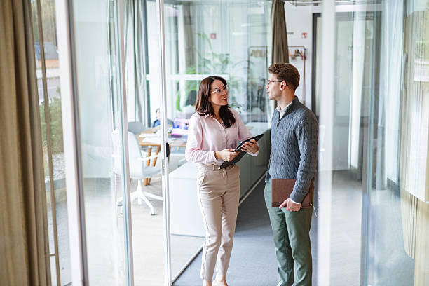 istock Smart Casual Business Discussion in Office Corridor 2243561985