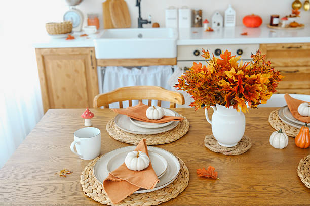 istock Autumn table setting with pumpkins and fall leaves in a ceramic pitcher. 2243562257