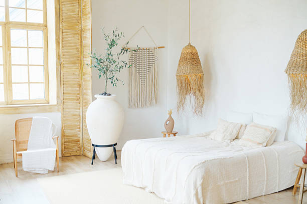 istock Bright bedroom interior decor with natural textures and a large vase with a plant. 2243562270