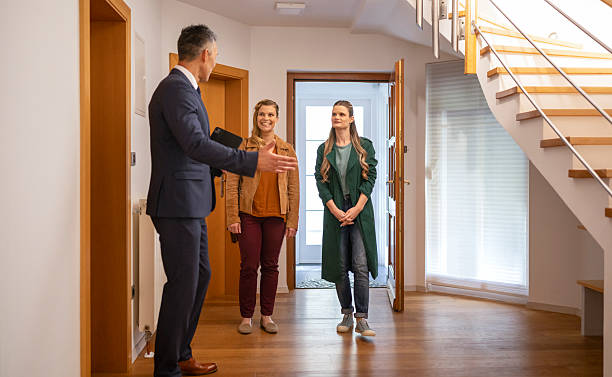 istock Real estate agent showing house to customers 2243563619