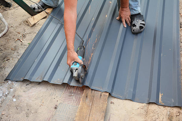 istock Roofer contractor is cutting with a power angle grinder a corrugated metal roofing sheet, a metal roof tile. 2243563744