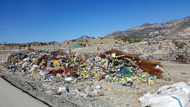 istock Vast Open Waste Landfill Site with Garbage and Mountains 2243568273